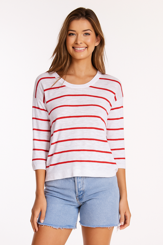 Woman wearing a white long-sleeve shirt with red stripes and blue shorts on a white background